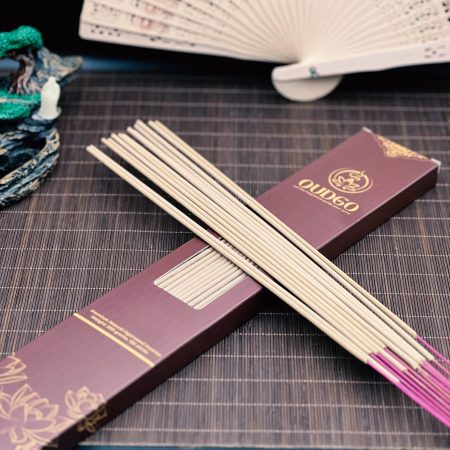 Long agarwood incense sticks displayed across an open Oudgo box
