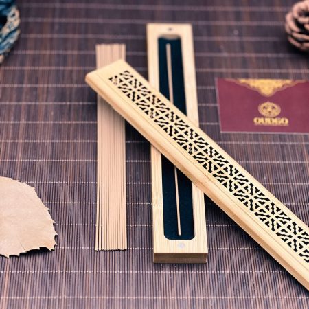Coreless agarwood incense sticks with an open carved wooden incense holder